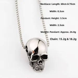 Close-up of polished silver skull pendant on bead chain showing detailed bone texture