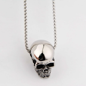 Macro view of vintage silver skull pendant showing retro stainless steel texture