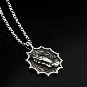 Vintage steel prayer hands pendant necklace with starburst design on a black box chain