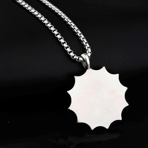 Polished silver stainless steel prayer pendant with box chain on black leather background