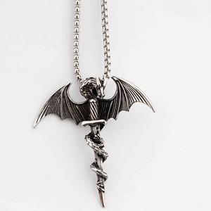 Detailed view of silver dragon wrapping around a sword pendant in vintage stainless steel