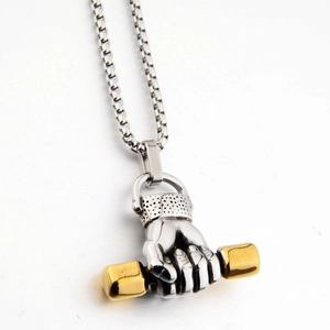 Detailed close-up of two-tone barbell pendant with silver hand on a robust box chain