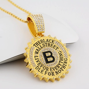Detailed close-up of a gold-plated B-letter pendant with sparkling pavé zircons