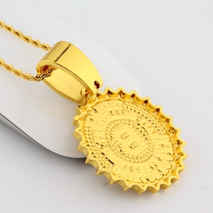 Close-up of golden sun-shaped pendant with double B logo on a twisted rope chain