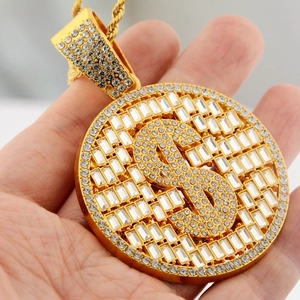 Macro view of gold hip-hop dollar sign pendant with cubic zirconia on cuban chain