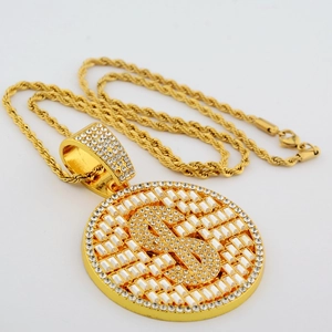 Macro view of gold hip-hop dollar sign pendant with sparkling pavé cubic zirconia