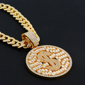 Detailed close-up of hip-hop gold plated Cuban link chain with dollar sign pendant