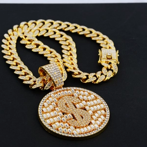 Close-up of iced out dollar sign pendant on golden Cuban link chain for hip-hop style