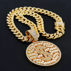 Close-up of golden hip hop cuban chain featuring a large iced-out dollar sign pendant