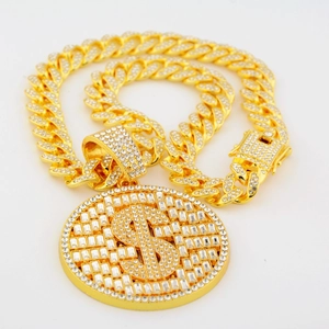 Close-up of iced out dollar sign pendant with sparkling cubic zirconia on gold cuban link chain