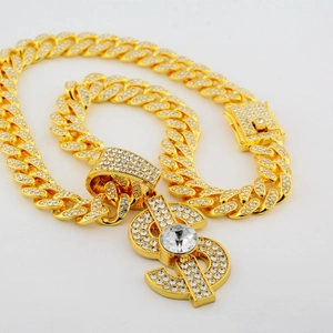 Hip hop gold Cuban link necklace with iced out dollar sign pendant and pavé rhinestones