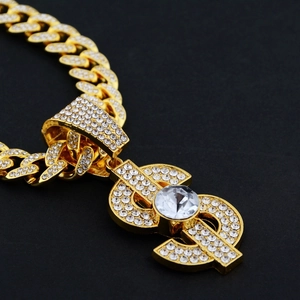 Macro shot of gold Cuban link chain with a micro-paved iced out dollar sign pendant