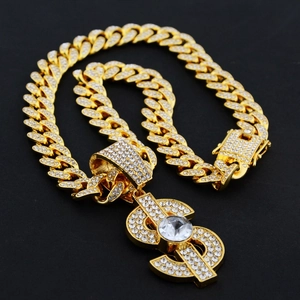 Macro shot of hip hop dollar sign pendant with sparkling diamonds on golden Cuban chain