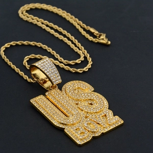 Macro shot of hip hop pendant with USA BOY letters and white zircons on a rope chain