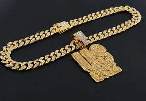 Detailed macro of gold plated US BOY letter pendant with sparkling cubic zirconia pavé