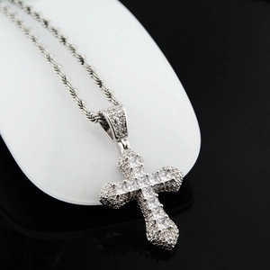 Gros plan d'un pendentif croix hip-hop avec oxydes de zirconium carrés et chaîne corde