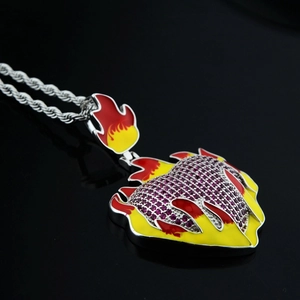 Macro shot of a flaming heart pendant with red rhinestones and silver rope chain