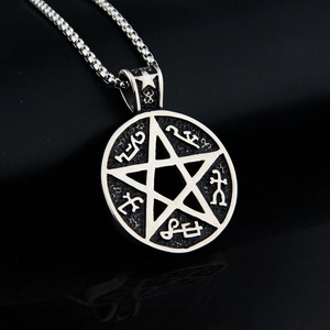 Close-up of pentagram pendant with alchemical symbols and a silver box chain