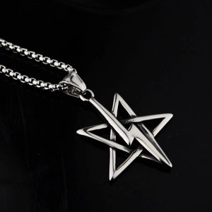 Detailed close-up of a stainless steel lightning star pendant on a classic box chain link