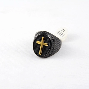 Detail view of men's black textured ring with golden cross and size 12 label