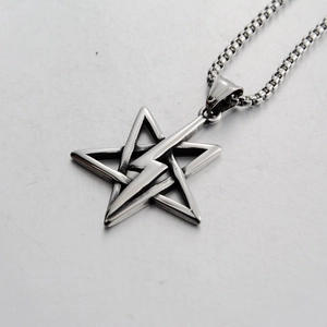 Macro shot of stainless steel lightning bolt and pentagram pendant on a box chain