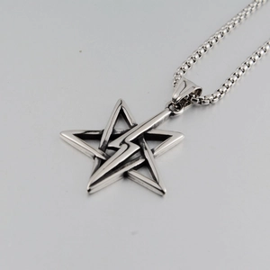 Detailed view of hip-hop star and lightning pendant with silver titanium steel ball chain