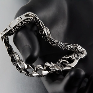 Close-up of retro titanium steel Cuban bracelet with intricate tribal totem engravings