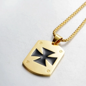 Macro detail of golden box chain and iron cross rectangular pendant for men