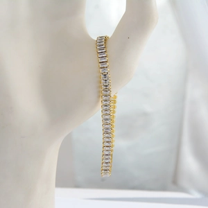 Detail of 18K gold-plated tennis bracelet with rectangular clear cubic zirconia stones
