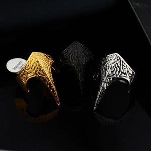 Three gothic claw rings set in gold, black, and silver stainless steel with embossed texture