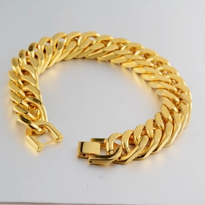 Men's bold golden Cuban link bracelet in stainless steel with a secure folding clasp