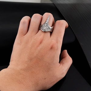 Detail view of gothic eagle claw ring with intricate retro patterns on finger