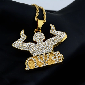 Vista macro del ciondolo hip hop dorato con lettere Omega Psi Phi e cristalli bianchi lucidi