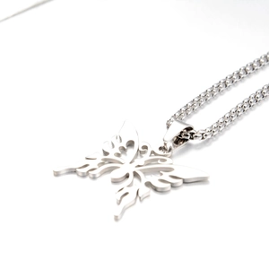 Macro view of a silver butterfly pendant with box chain made of titanium steel