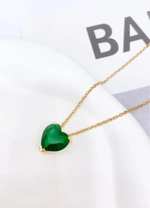 Elegant gold titanium necklace featuring a heart-shaped green gemstone pendant in minimalist style