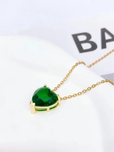 Elegant gold titanium necklace with a heart-shaped deep green emerald gemstone pendant