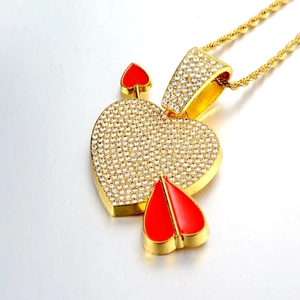 Iced out gold heart pendant with a red arrow and matching twisted rope chain necklace