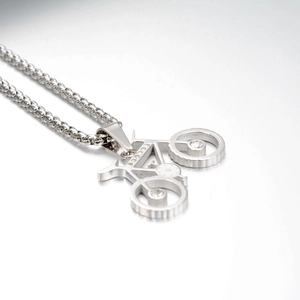 Détail du collier pendentif vélo argenté avec cristaux brillants sur chaîne à billes