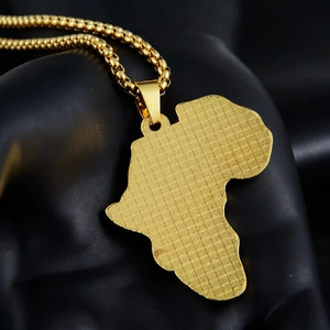 Macro shot of gold-plated Africa map pendant with woven texture on a bead chain