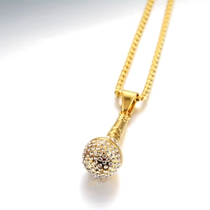 Detailed close-up of hip-hop microphone pendant with gold finish and sparkling rhinestones