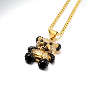Detailed view of hip hop panda pendant with pavé set crystals and gold finish