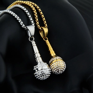 Close-up of hip hop microphone pendants in gold and silver with sparkling rhinestones