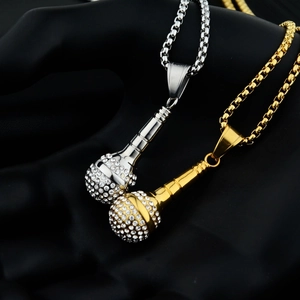 Close-up of hip-hop microphone pendants with rhinestones in silver and gold colors