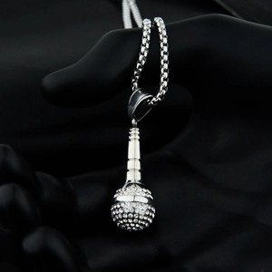 Macro shot of silver hip-hop microphone pendant with rhinestones on a box chain