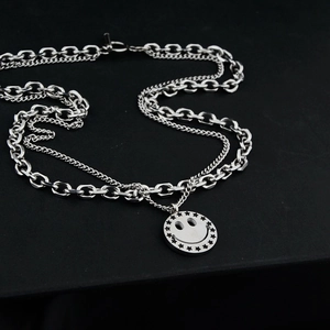 Double-layered titanium steel necklace featuring a smiley face pendant with star details