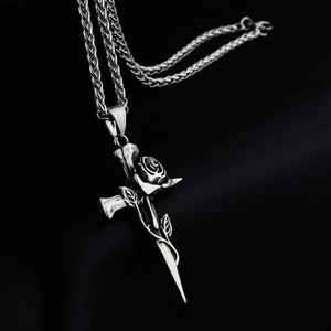 Gothic rose sword cross pendant necklace in vintage steel on a textured black background