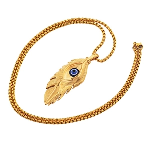 Detail of gold feather pendant with blue evil eye and box chain for hip-hop style