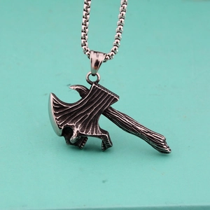 Retro hip-hop skull axe pendant with vintage steel chain on a solid blue background
