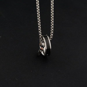Close-up of double ring pendant necklace with LOVE and The only eternal engravings