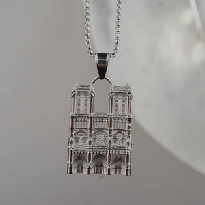 Detailed relief of Notre Dame cathedral pendant on a silver square box chain necklace